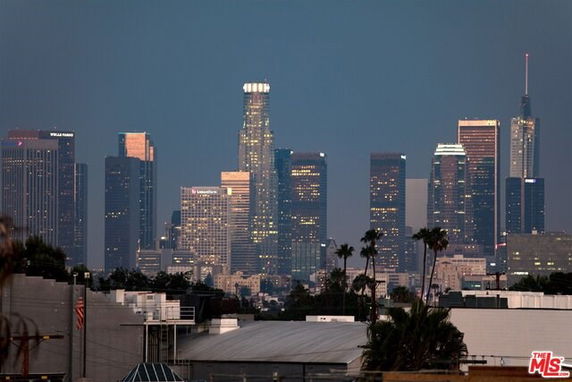 Panoramic view of a city skyline with modern high-rise buildings at dusk.