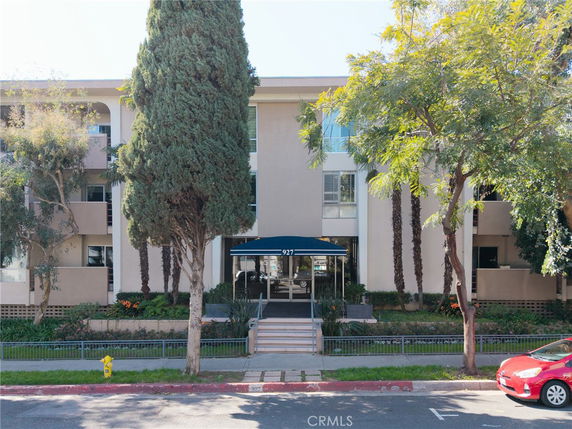 Front view of a multi-story residential building with a central entrance.
