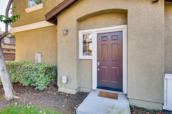 Front view of a house with a brown door and small window