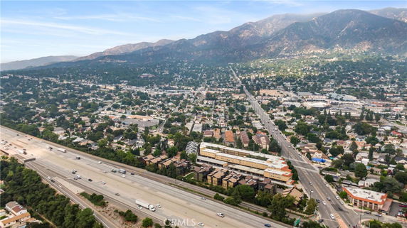 Wide-angle view of a residential and commercial area with mountains in the background.