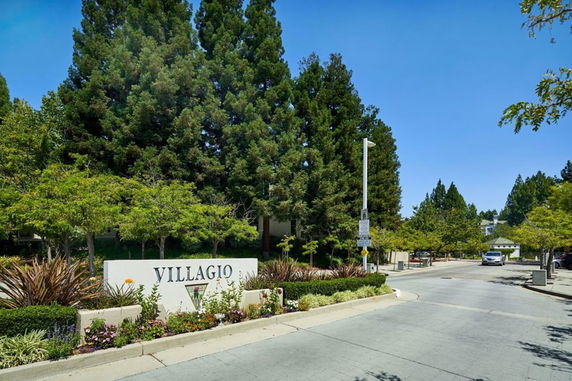 Entrance view of a residential area with a sign reading 'Villagio'.