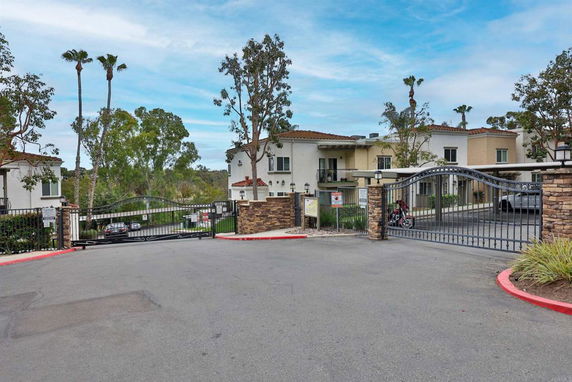 Front view of a gated residential area with multiple buildings.
