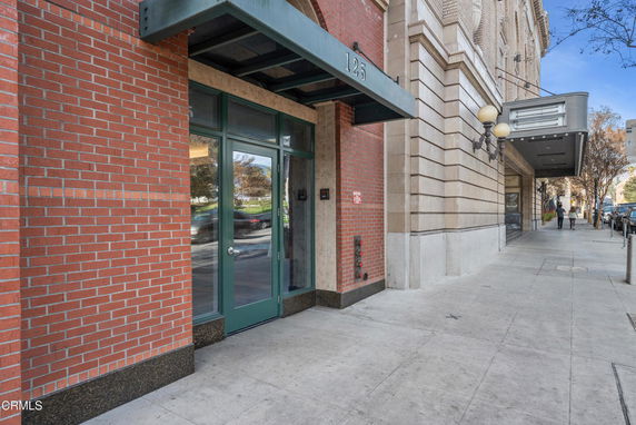 Front view of a building entrance with brick and stone facade.