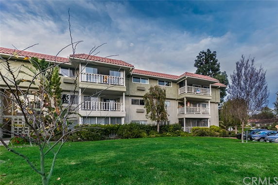 Front view of a multi-story residential building with balconies.