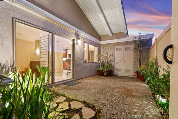 Front view of a house with sliding glass doors leading to an exterior area.