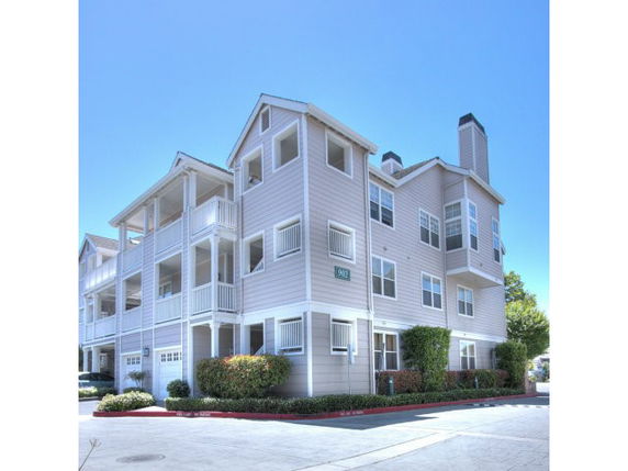 Front view of a multi-story residential building with balconies.