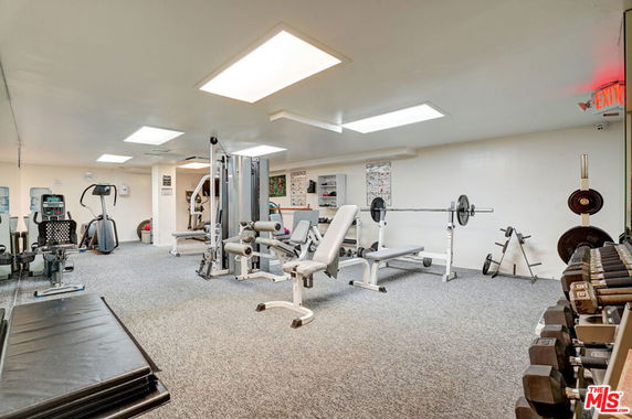 Indoor gym area with various fitness equipment.