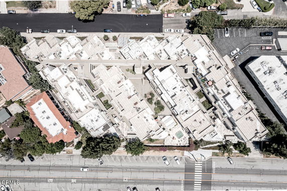 Aerial view of a complex building rooftop with multiple sections.
