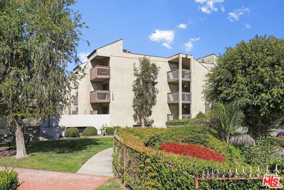 Front view of a multi-story apartment building with balconies.