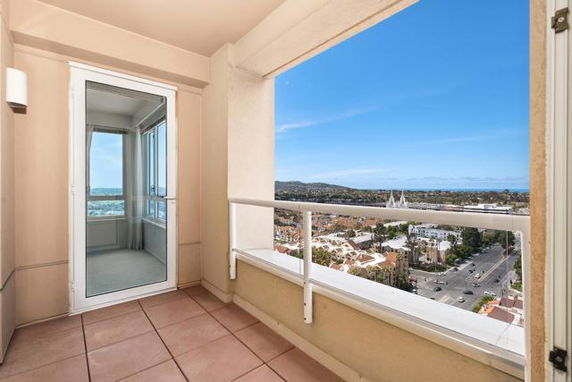 View from a balcony overlooking surrounding areas and horizon.