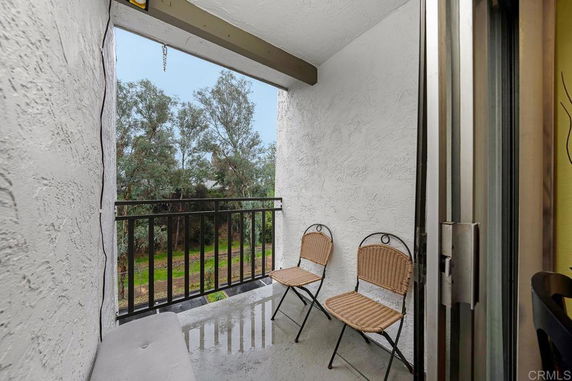 Balcony view with railings and trees in the background