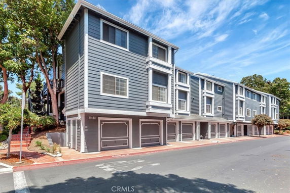 Front view of a multi-story building with multiple garage doors.