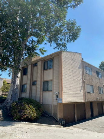 Front view of a two-story apartment building with multiple windows and garage parking.