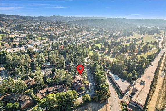 Panoramic view of a residential area surrounded by trees and greenery.