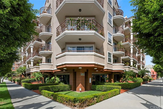 Front view of a multi-story apartment building with balconies.