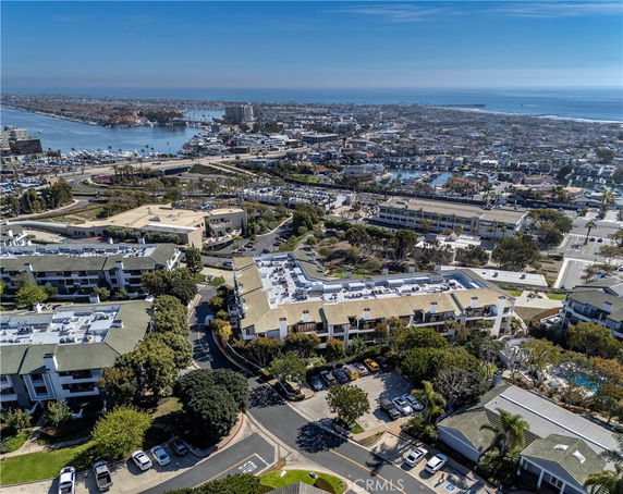 Aerial view of a coastal city with residential buildings and a waterfront.