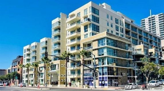 Front view of a multi-story apartment building with balconies.