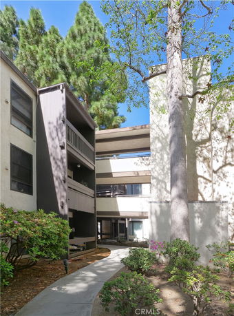 Front view of a multi-story apartment building with balconies.