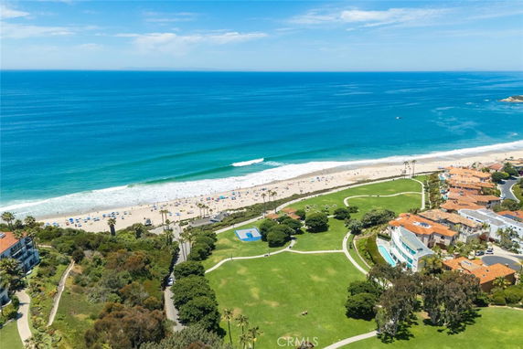 Wide angle view of the oceanfront and surrounding areas with a beach and nearby houses.
