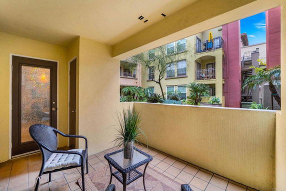Outdoor sitting area with view of surrounding apartment buildings.
