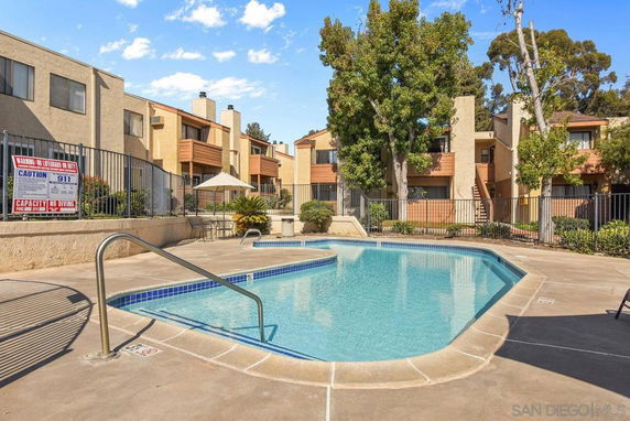 Outdoor swimming pool with surrounding apartment buildings.