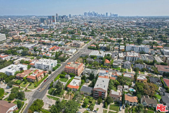 Panoramic view of an urban area with numerous buildings and a city skyline in the distance.
