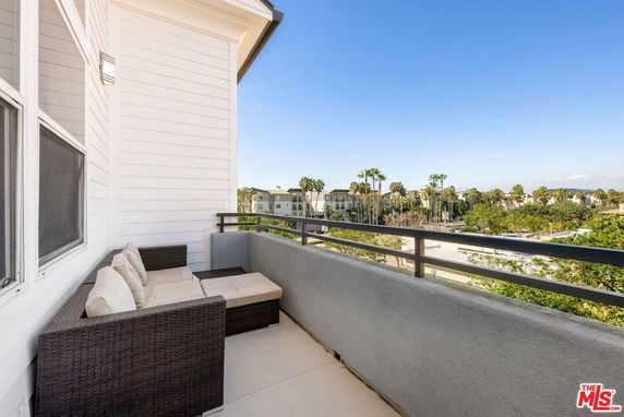 Panoramic view from a balcony with outdoor seating and railing.