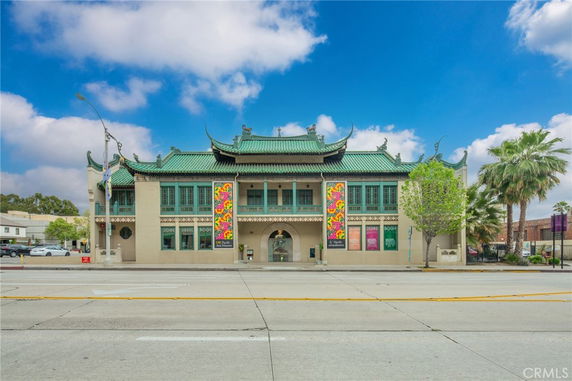 Front view of a two-story building with traditional architectural elements and banners on the facade.