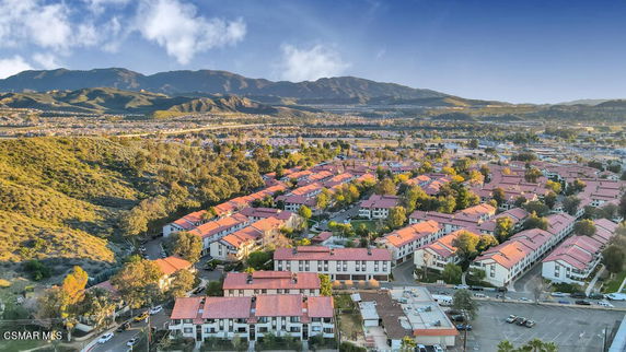 Wide-angle view of a residential community with multiple identical buildings and surrounding hills.