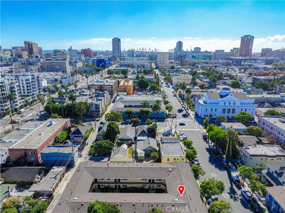 Panoramic view of an urban area with numerous buildings and a distant cityscape.