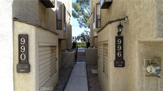View of two building entrances with signs numbered 990 and 996.