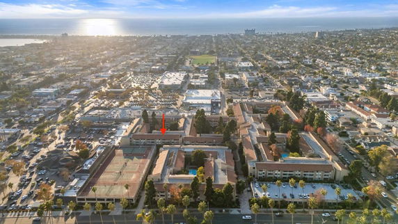 Panoramic view of a cityscape with multiple buildings and a distant coastline.