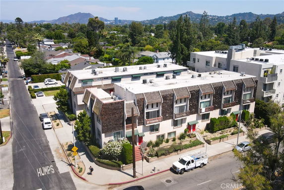Aerial view of a multi-story apartment building with distinctive triangular roof accents.