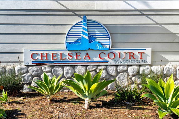Signage of Chelsea Court Condominiums on a stone wall.