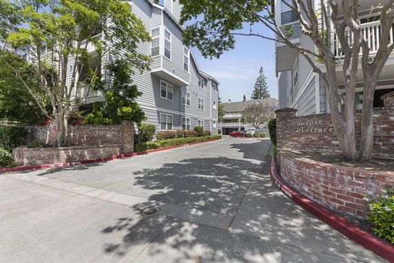 Front view of apartment buildings with brick signage.