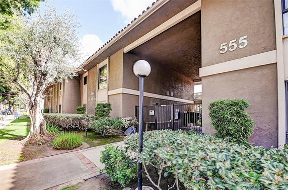 Front view of a multi-story building with a visible entrance and the number 555.