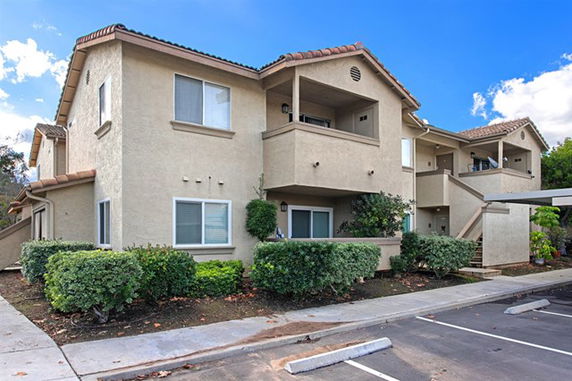 Front view of a two-story apartment building with balconies.