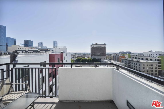 Panoramic view of city buildings from a rooftop.