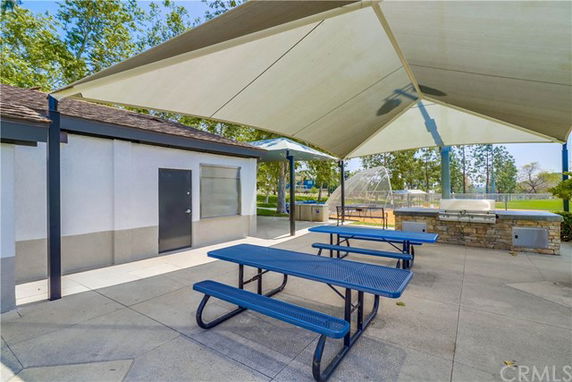 Covered outdoor area with benches and a view of a playground.