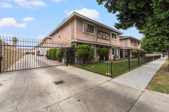 Front view of a two-story residential complex with gated entrance.