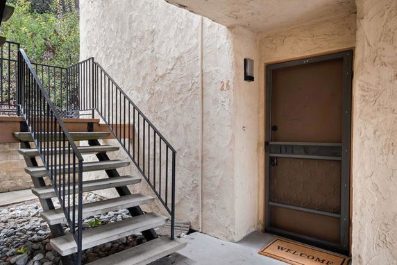 Entrance view with staircase leading to a door in a building.