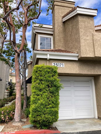 Front view of a two-story house with a single garage.