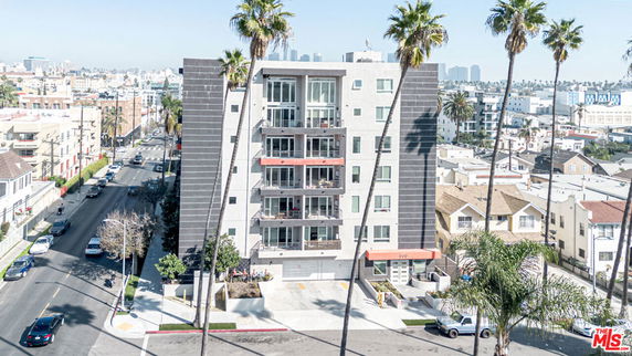 Front view of a multi-story apartment building with a modern facade.