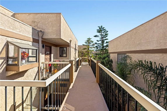 Exterior view of a multi-story building walkway connecting apartments.