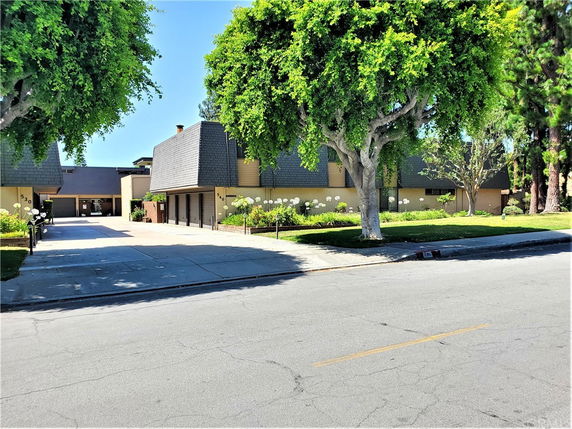 Front view of a building with a modern design and garage doors.