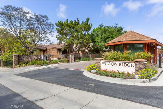 Front view of a building with a designated entrance area and a sign indicating 'Willow Ridge'.