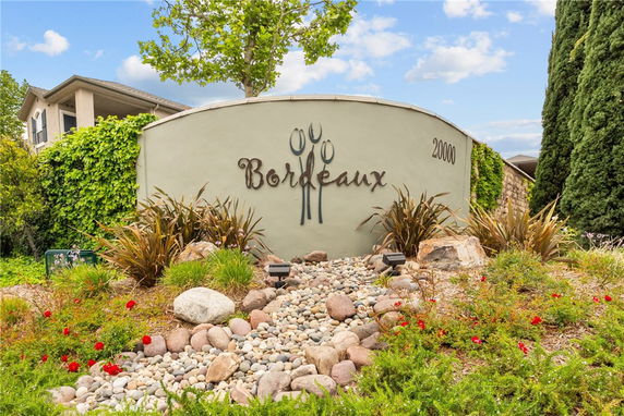 Front view of a building with a curved wall featuring the name 'Bordeaux' and surrounded by landscaping.