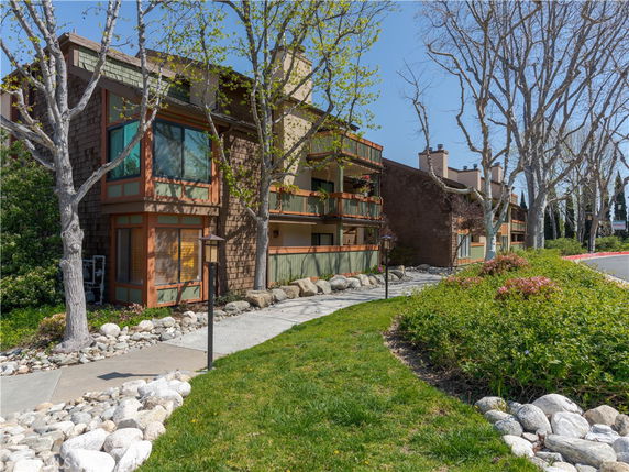 Front view of a multi-story residential building with balconies.