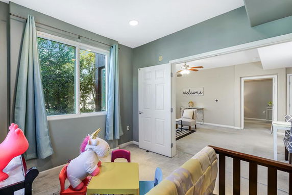 Indoor play area with children's toys and a small table.