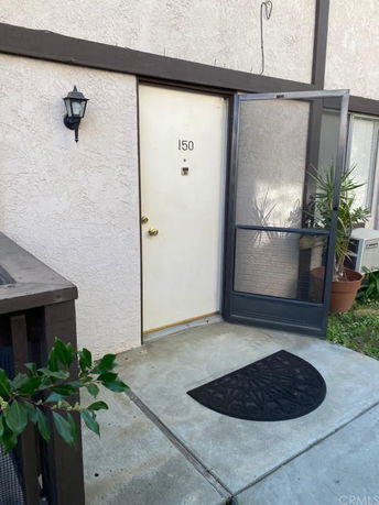 Front view of a door with the number 150 on a multi-story building.